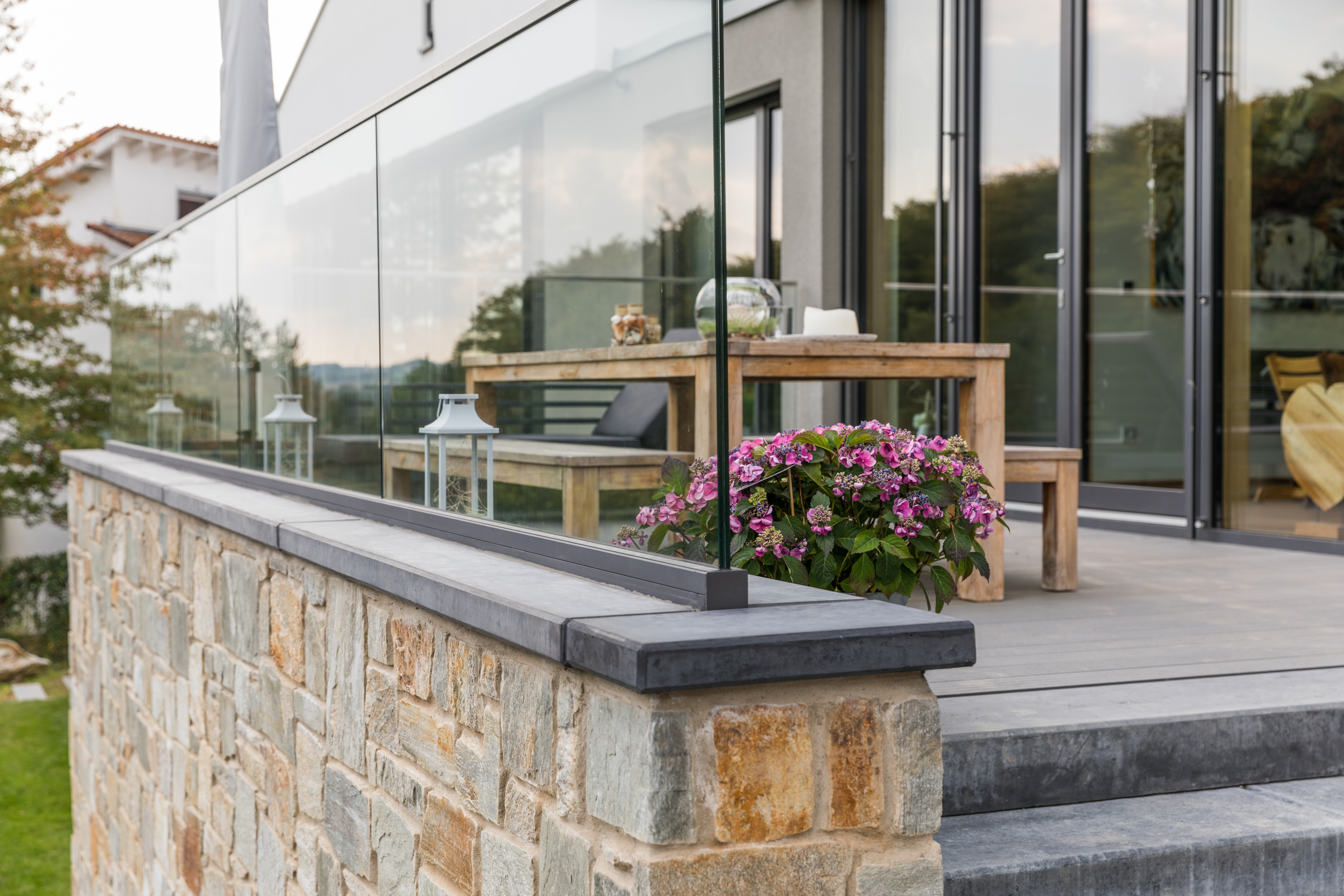 Natursteinmauer mit Betonabdeckplatte an einer Terrasse